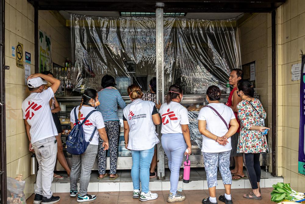 In the Tondo neighbourhood of Manila, MSF volunteers invite staff and customers at a local bakery to get their chest x-rayed at the free tuberculosis screening held by MSF. Manila, Philippines, March 2023. © Ria Kristina Torrente