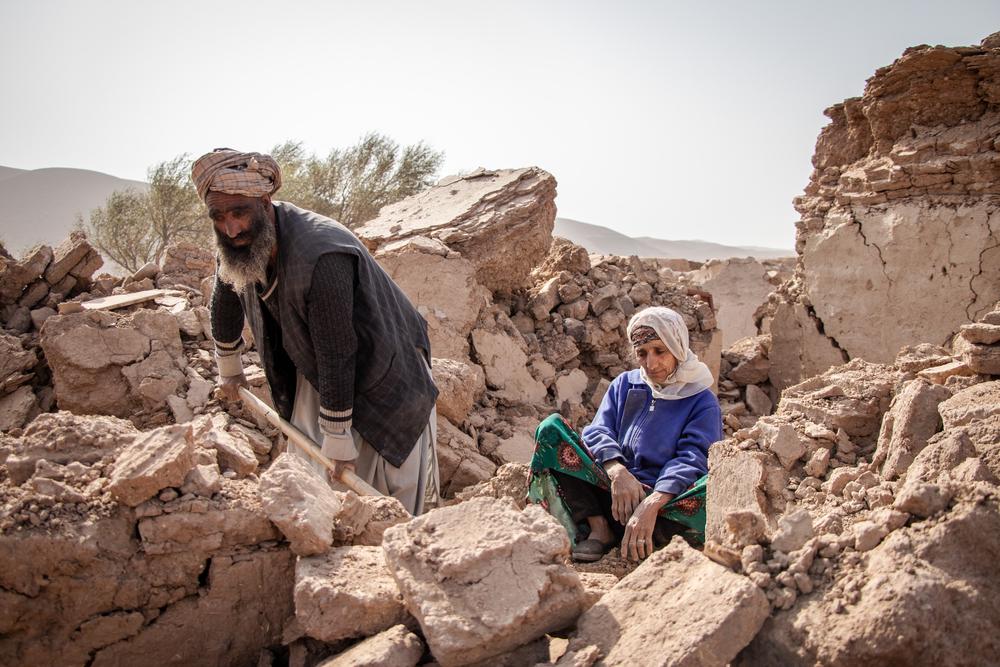Abdul Salaam digs through the rubble of what used to be his home with a shovel, as his mother watches on, after a 6.3 magnitude earthquake struck the region five days earlier. Herat, Afghanistan, 12 October 2023. © Paul Odongo/MSF