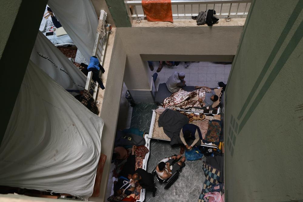 An above view of a crowded hallway at Al-Aqsa hospital, where patients and displaced people are forced to live. Middle Area, Gaza, Strip, Palestine, 29 November 2023. © Mohammed Abed