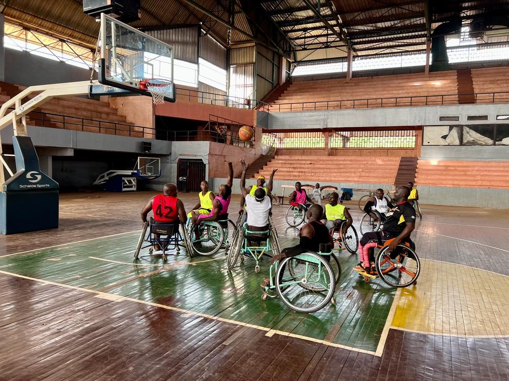Bienvenue (third from left) reaches for the ball during a game of basketball. After an accident in 2016, Bienvenue had his right leg amputated by an MSF surgical team at SICA hospital. He received medical care and physiotherapy treatment from MSF. “After my surgeries, I received physiotherapy... Playing sports allows us to release energy and strengthen our disabilities, helping us forget our past and current situations. I train five times a week, a routine I've maintained since 2017.” Bangui, Central Africa