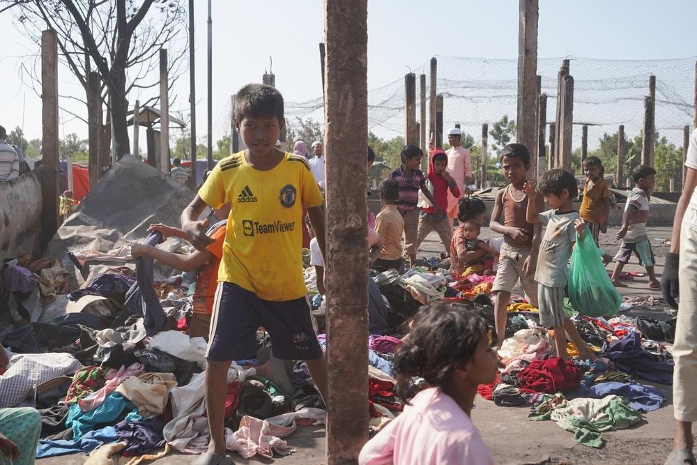 Children choose from a pile of donated clothes. The Rohingya community responded quickly. As many people from Camp 5 lost everything in the fire, refugees from other parts of the camp rushed to donate them clothes and food.