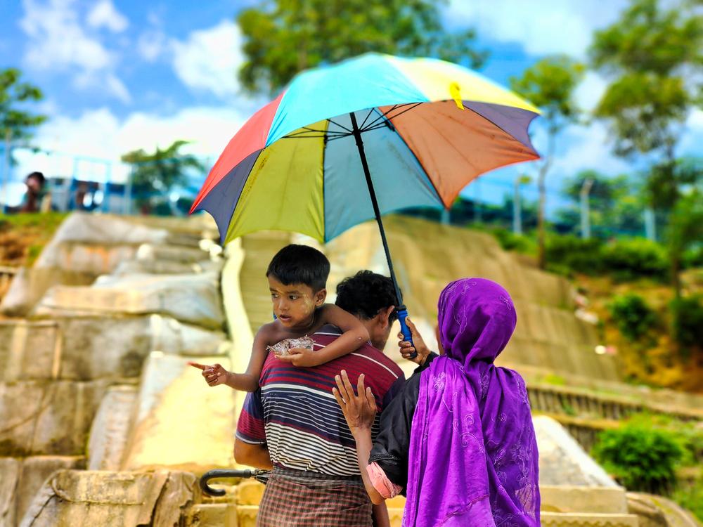 A Rohingya couple carry their sick child through the camp to find a doctor. Cox’s Bazar, Bangladesh, October 2023 © Sahat Zia Hero