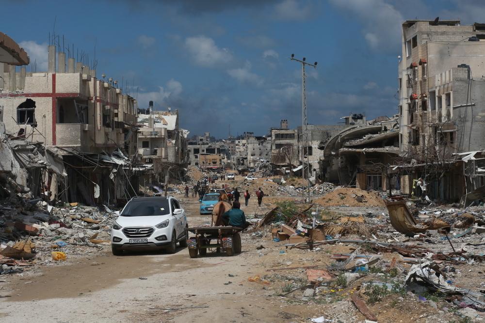 Displaced people walk between buildings destroyed by relentless violence and bombings in Gaza. Palestine, 6 May 2024.