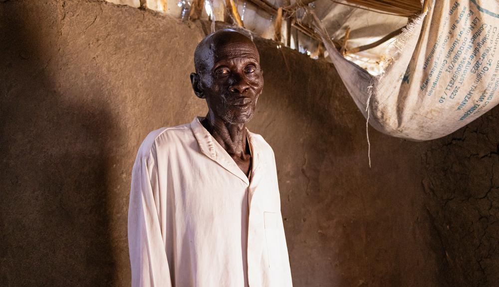 A TB/HIV patient is standing inside his house in Leer.