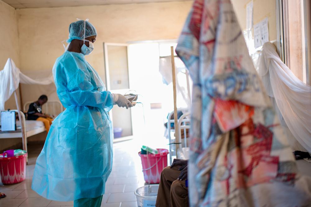 A nurse does a round to check on patients in the morning and to give them their medication against diphtheria at the Centre de Traitement Epidemiologique in Siguiri, Guinea.
