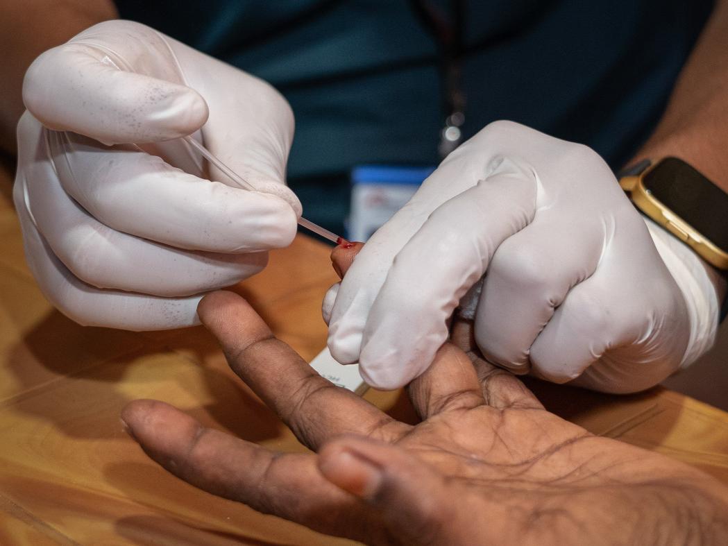 Doctors Without Borders staff is collecting blood sample from a patient to run Hep C rapid diagnostic test (RDT) at the Hep C consultation room of Hospital on the hill at Ukhiya, Cox’s Bazar. Bangladesh, May 2024. © Abir Abdullah/MSF
