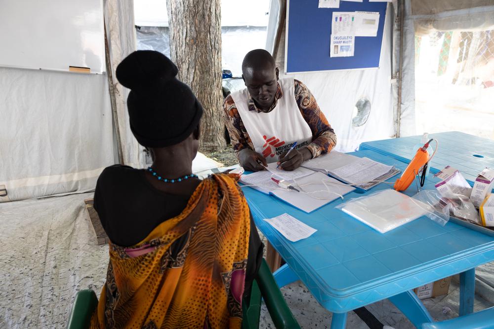 A Doctors Without Borders health worker is carrying out a consultation with a patient inside our clinic at Bulukat transit centre, Malakal, Upper Nile State, South Sudan.