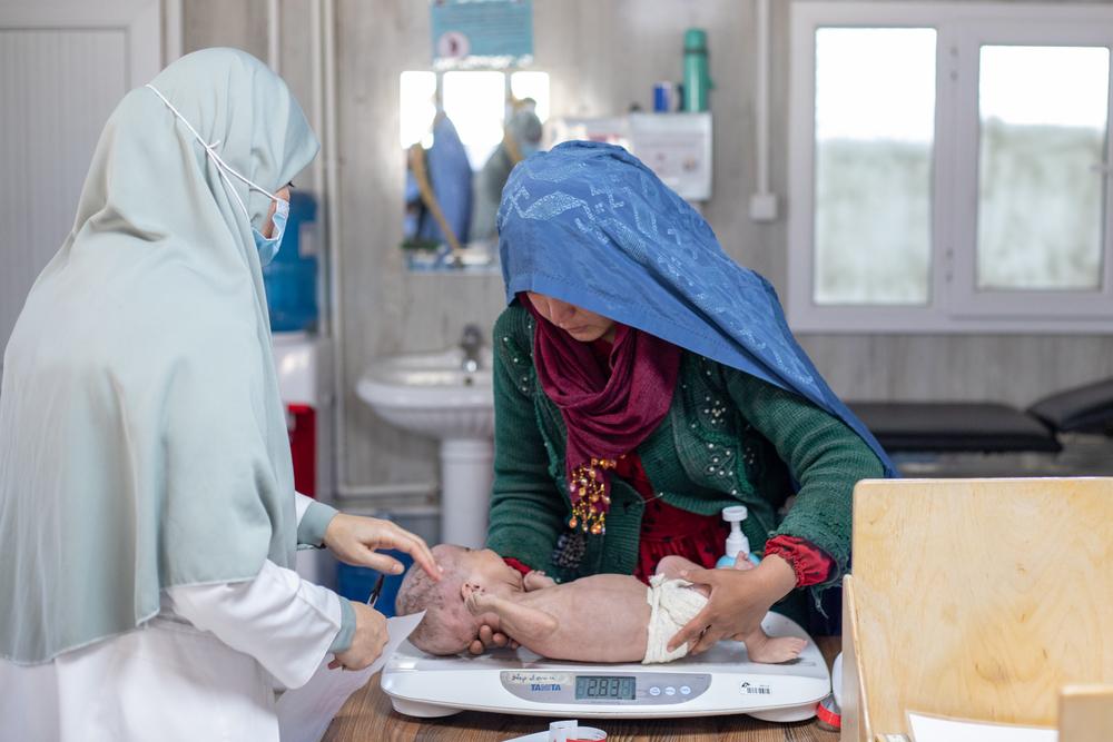 A patient is placed on a weighing scale to check his weight at Paediatric Care in Herat Regional Hospital.