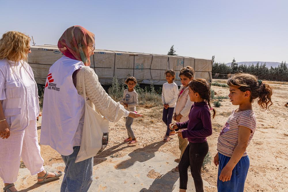 Doctors Without Borders teams are accompanied by children as they roam an informal tent settlement in Qaa, northeast Lebanon.