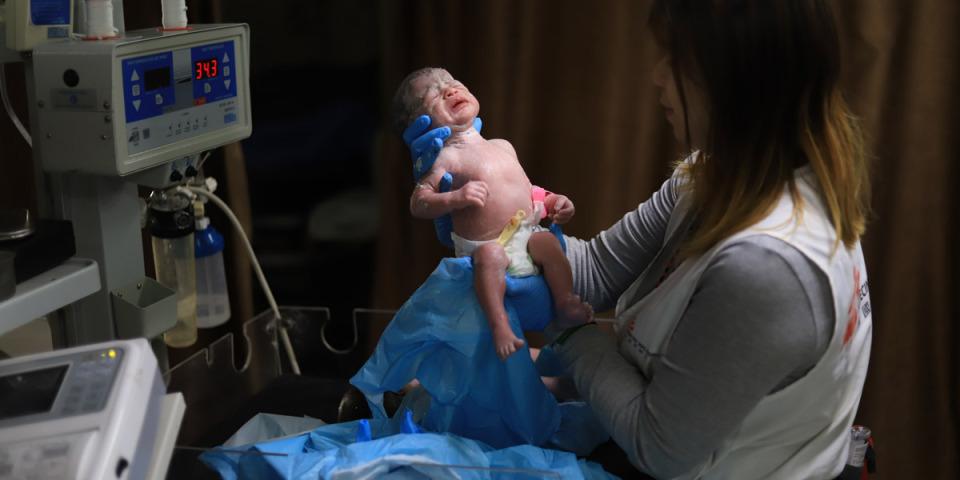 Hin So, MSF midwife activity manager checking on a newborn baby at Nasser Hospital, southern Gaza.