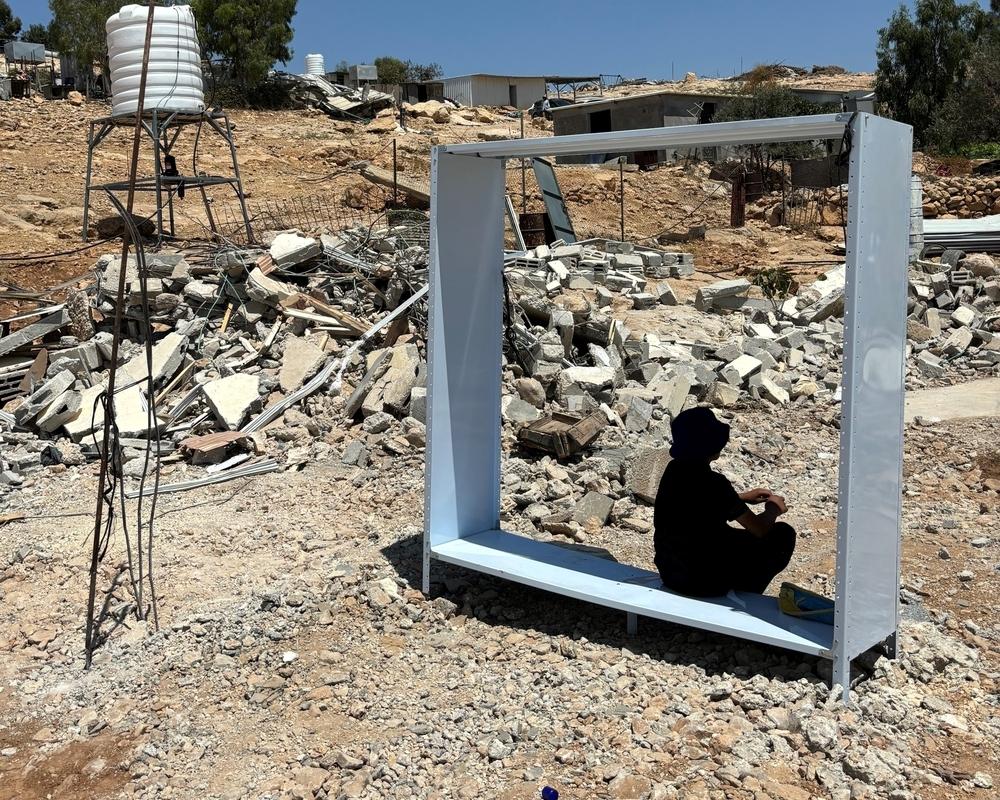 Palestinian teenager finding shelter from the sun after his home was suddenly demolished without warning in Umm al Kheir, Masafer Yatta, West Bank.