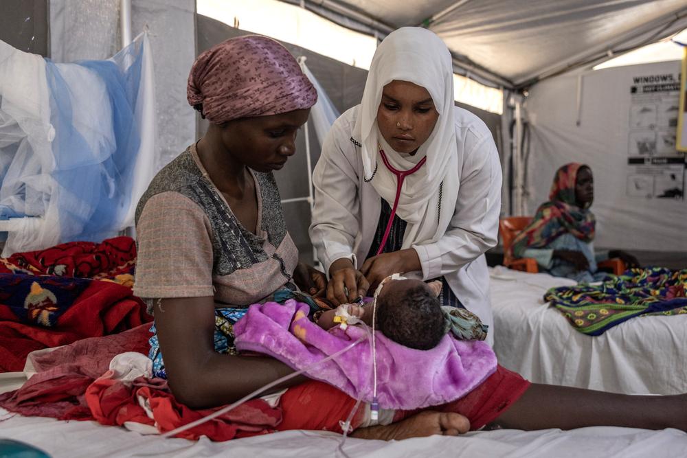 A Sudanese doctor examines a child in the pedeatric ward at the MSF Hospital in Metche, in eastern Chad.