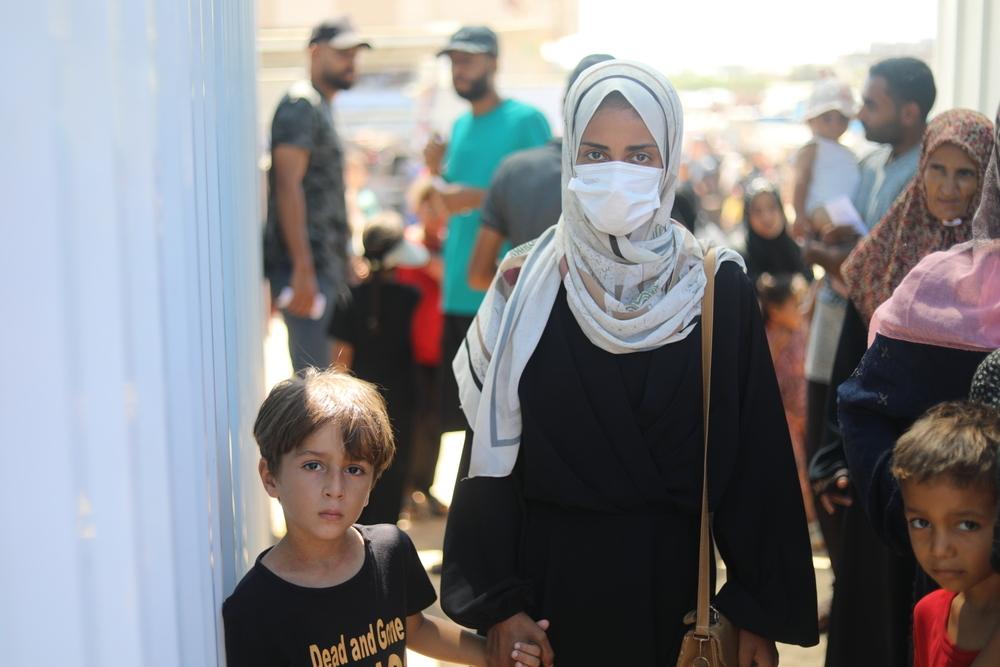 A Palestinian mother holds her son hand in Khan Younis, Gaza Strip. 