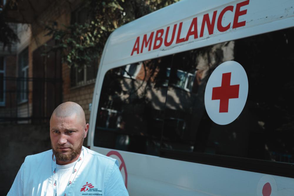 MSF feldsher is standing next to MSF ambulance in Donetsk region