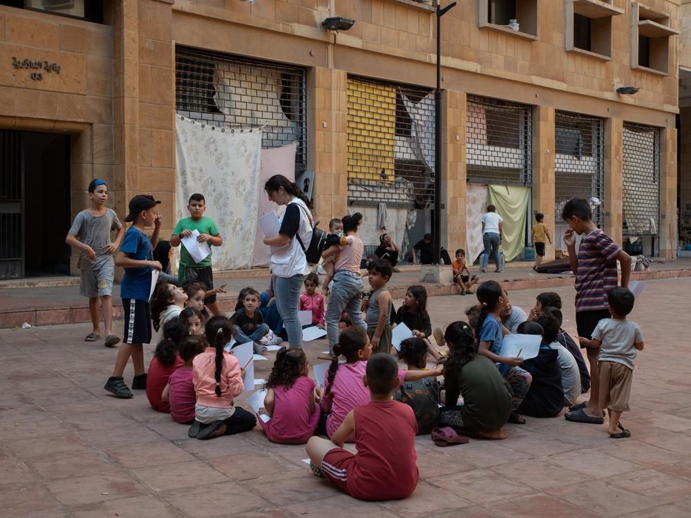 A Doctors Without Borders staff member organizes activities for the children of the Azarieh shelter, Beirut. Lebanon, October 2024. © Antoni Lallican/Hans Lucas