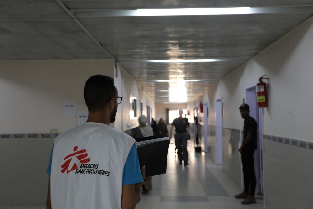 An infection prevention and control (IPC) assistant nurse, walks through the hallways of the paediatric department at the MSF-supported Nasser Hospital in southern Gaza.