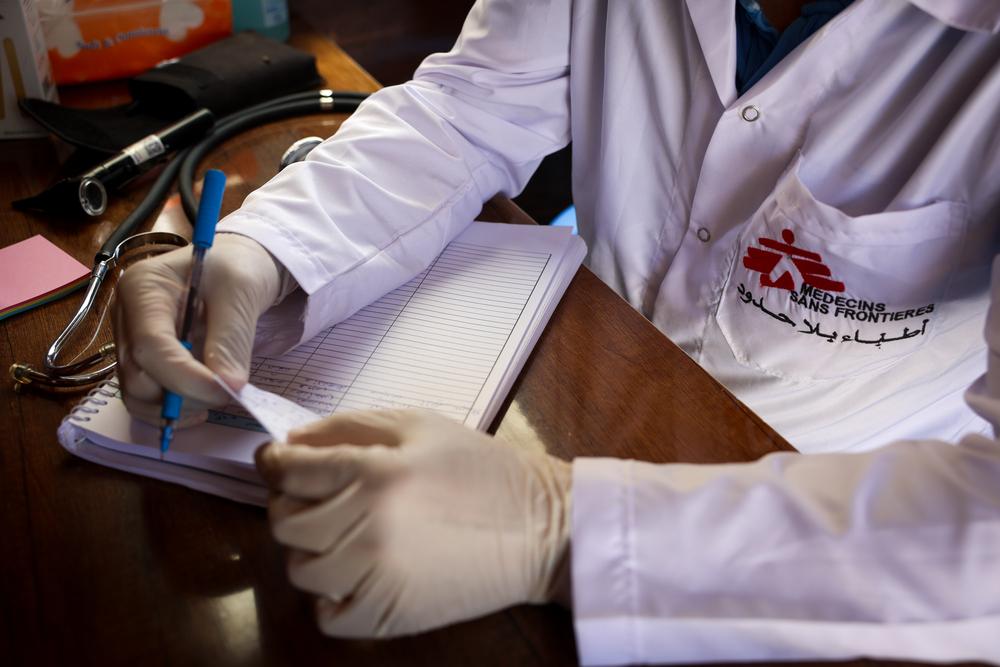 Inside MSF mobile clinic in Deir Hassan cluster camp, an MSF doctor writing prescription for the patients.