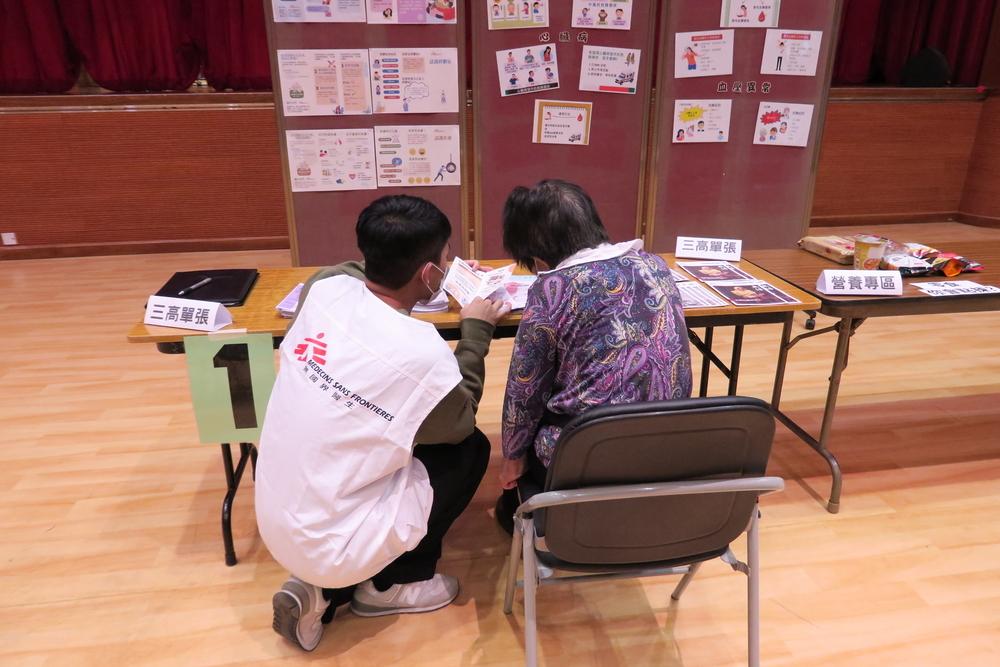 MSF staff interact with community member during an activity for homeless people in Hong Kong