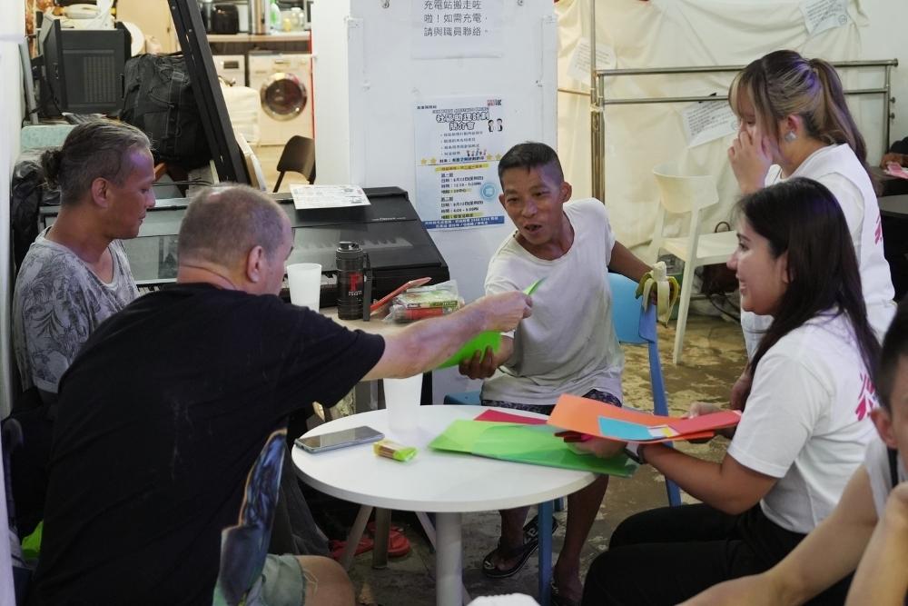 MSF staff interact with community members during a group activity in Hong Kong