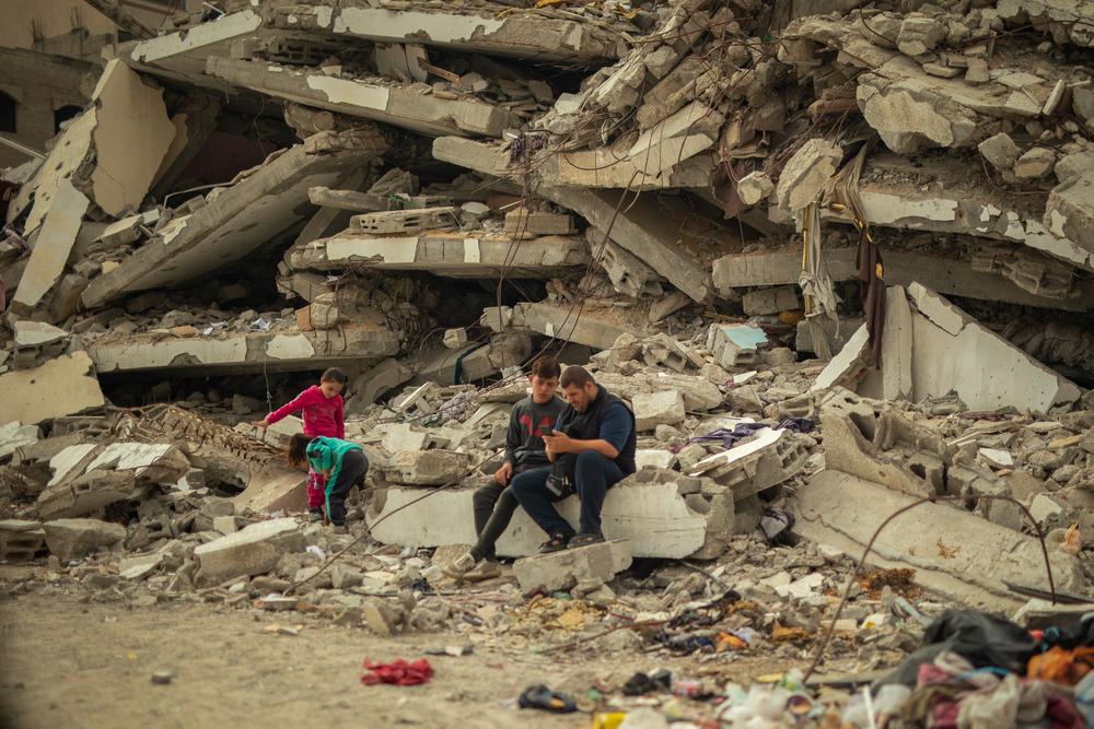  At Al Saraya in Gaza City, people are sitting on the rubble of their destroyed home, with their tent set up across from the debris.