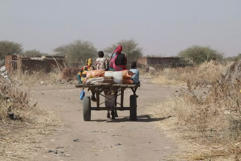 One of the families on their way home after receiving the food baskets in food distribution programme in Sudan.