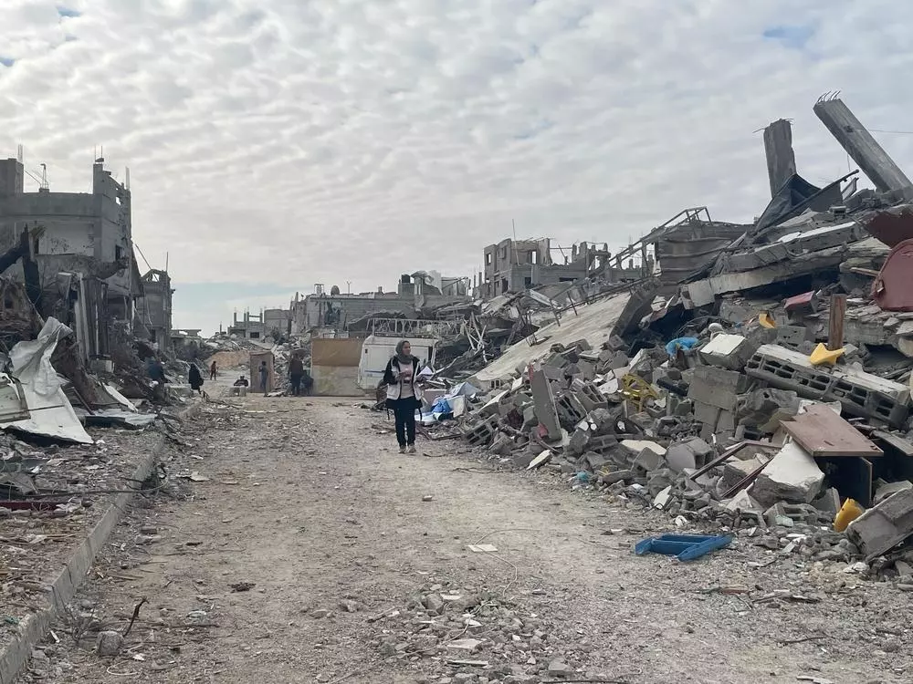 A woman walking through the ruins of Rafah city, southern Gaza.