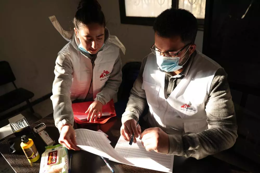 MSF medical team preparing medical data enter sheet so they can follow up with patients at MSF mobile clinic in east Ghouta, Syria.