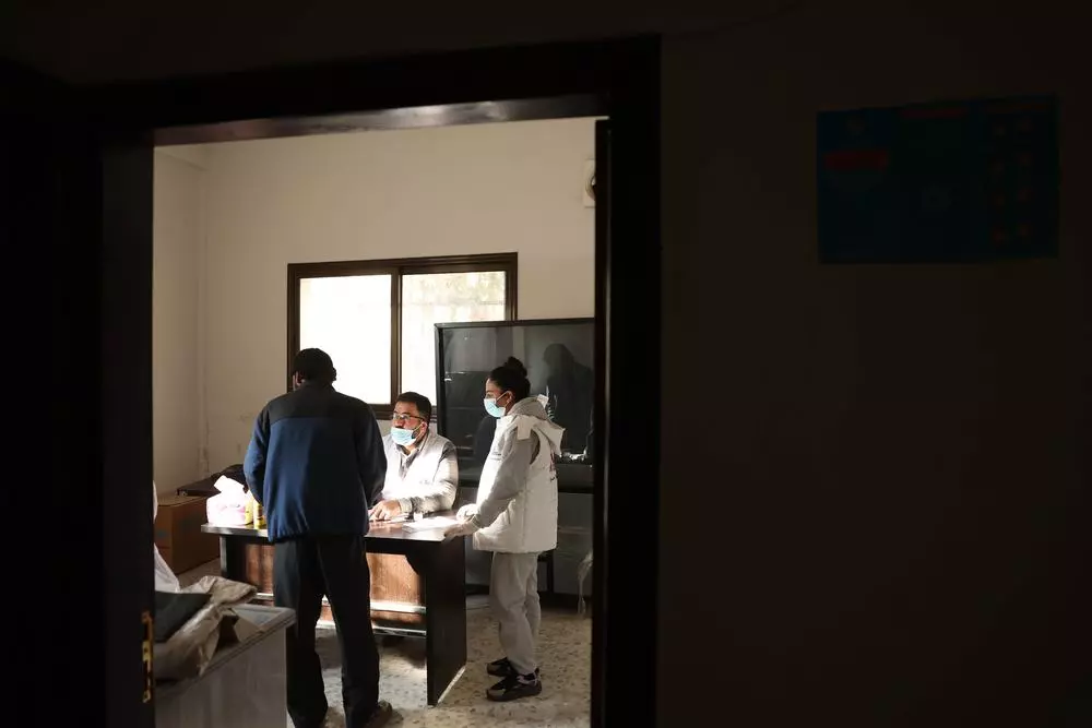 MSF team provide medical consultation to patient at MSF mobile clinic in east Ghouta, Syria.