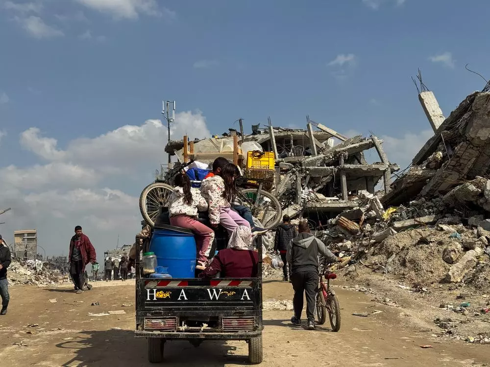 Displaced Palestinian family riding a tuktuk; coming back to settle in Beit Lahia city, north of Gaza strip.