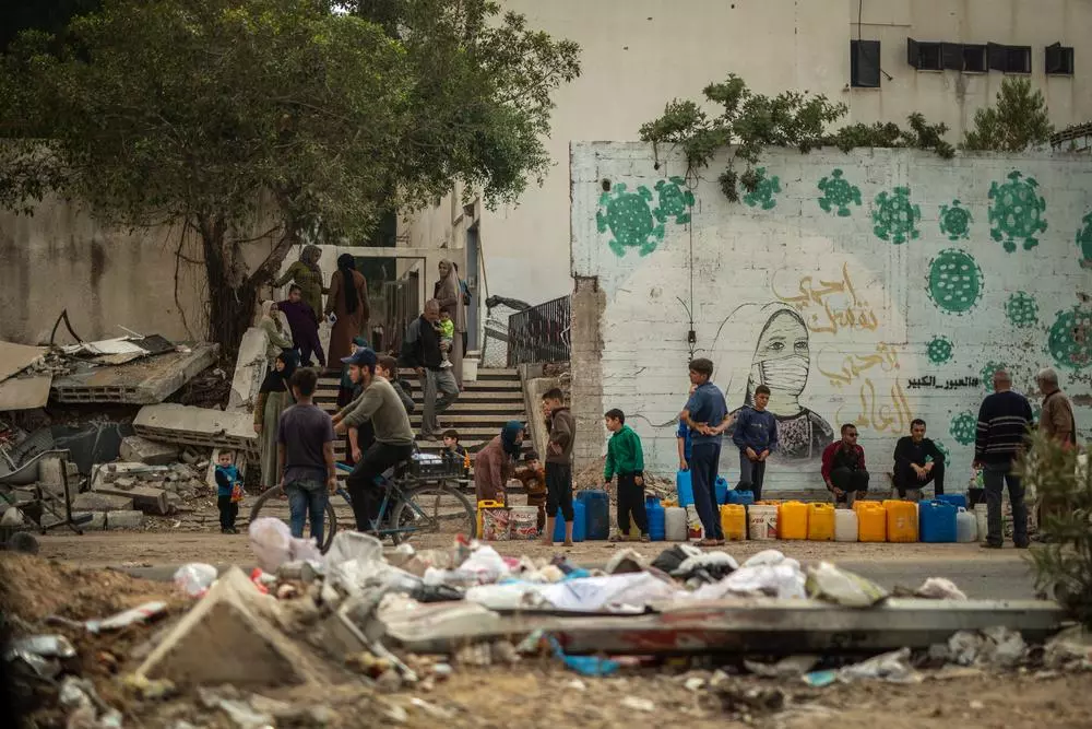 People are lined up to collect water in Gaza City.