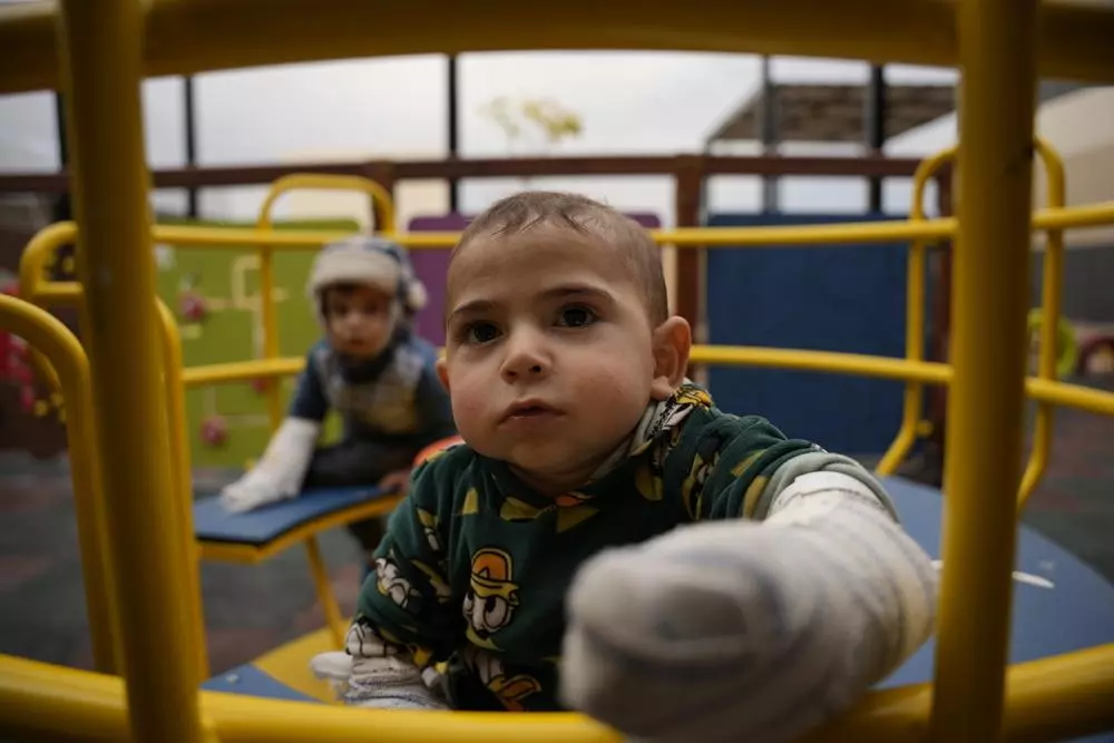 Young burns patients play in the recreational area of the MSF hospital