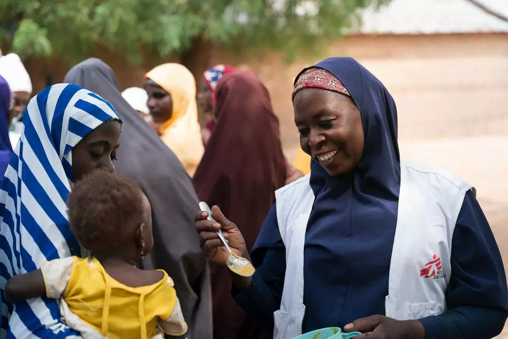 MSF staff with child