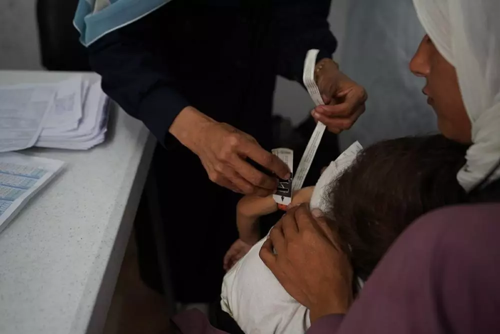 Child being examined for malnutrition