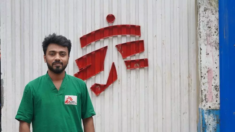 An MSF medical staff standing in front of Jamtoli Primary Healthcare Center at Rohingya refugee camp in Cox's Bazar, Bangladesh