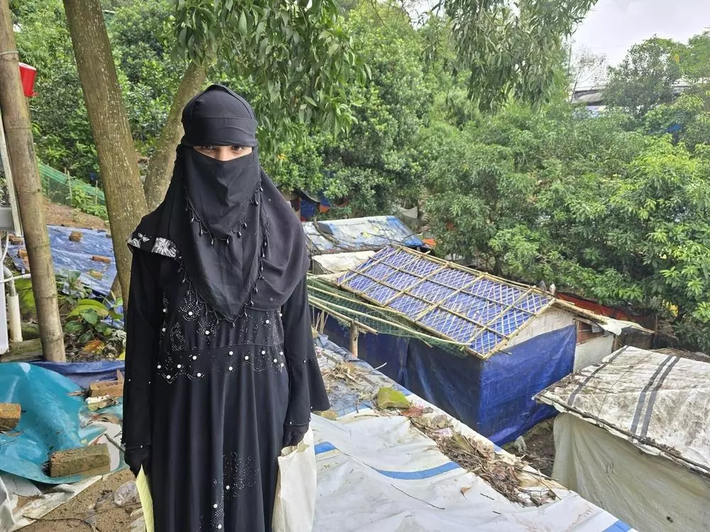 A Rohingya refugee receiving hepatitis C treatment at MSF's Balukhali clinic stands in front of the Rohingya refugee camp in Bangladesh.