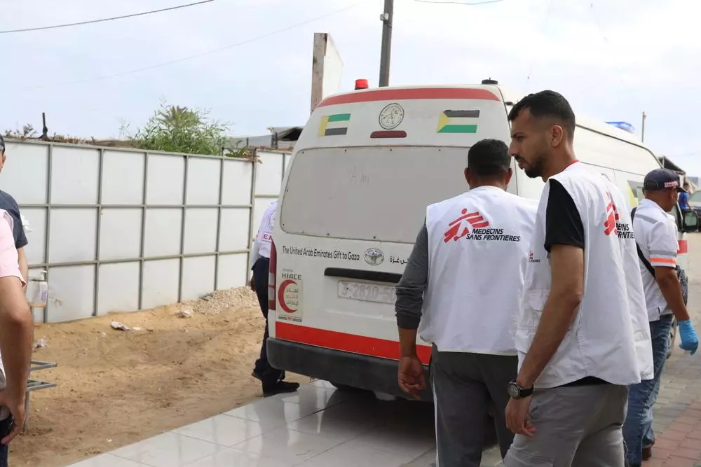 MSF staff standing near an ambulance
