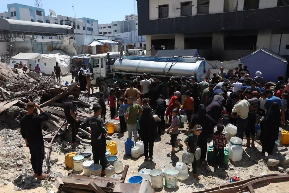 People collecting water from water truck