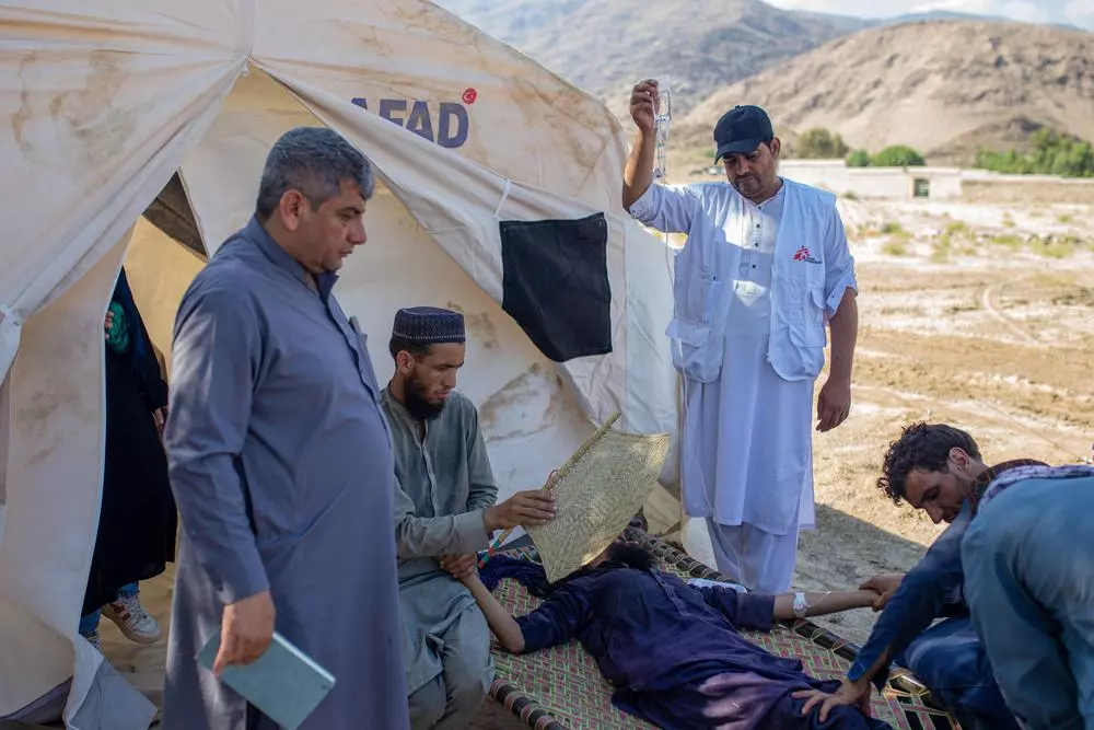 MSF staff helping patient