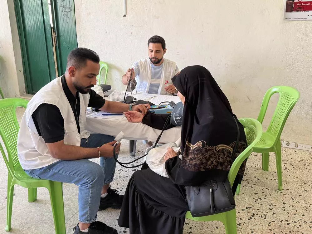 MSF nurse taking vital signs