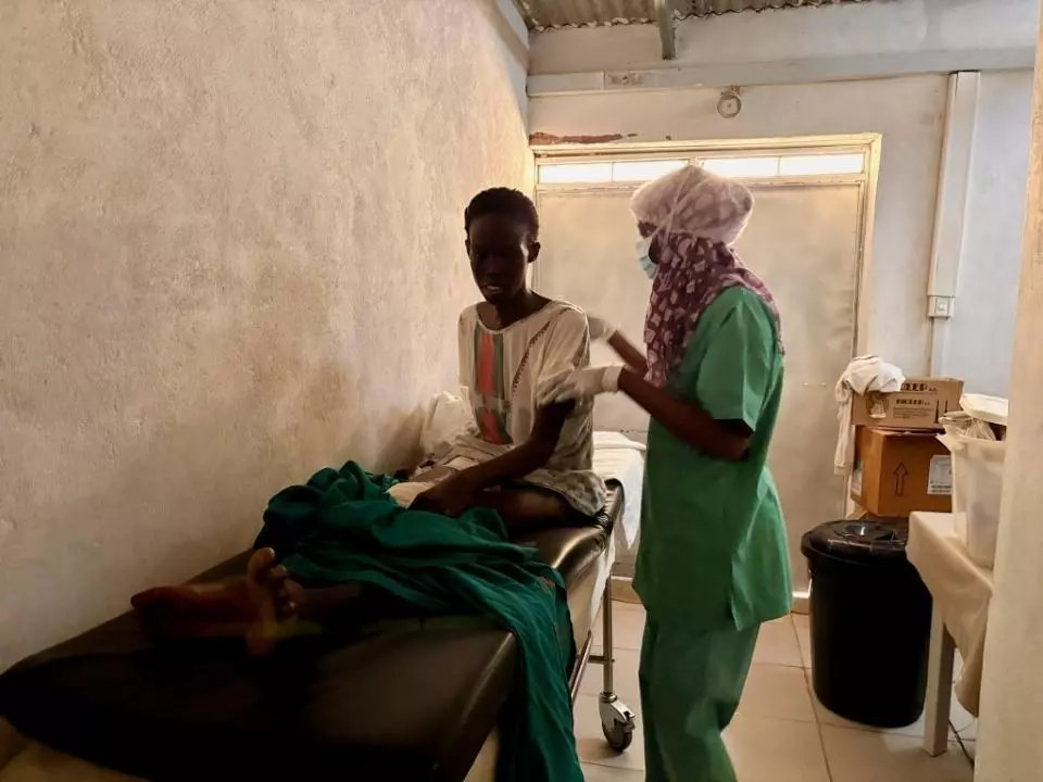 MSF nurse attending to patient