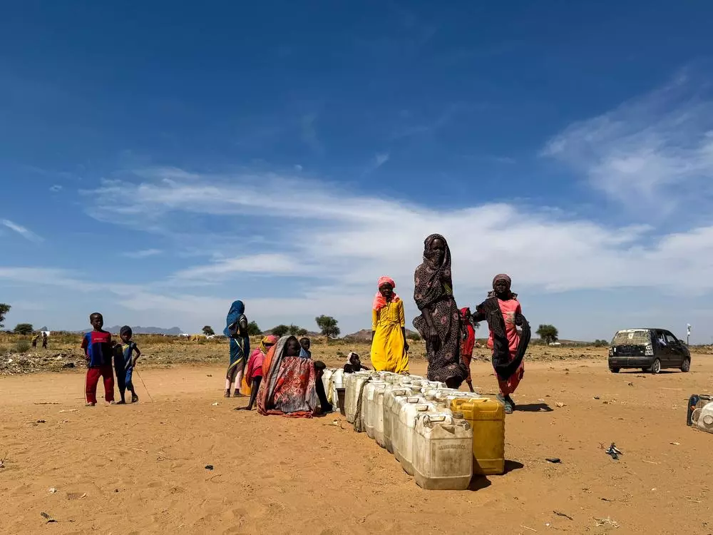 People standing by jerrycans