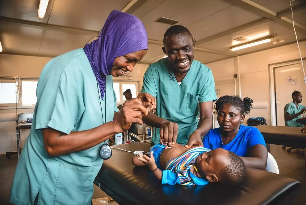 MSF medical staff examine a 6-month-old patient.