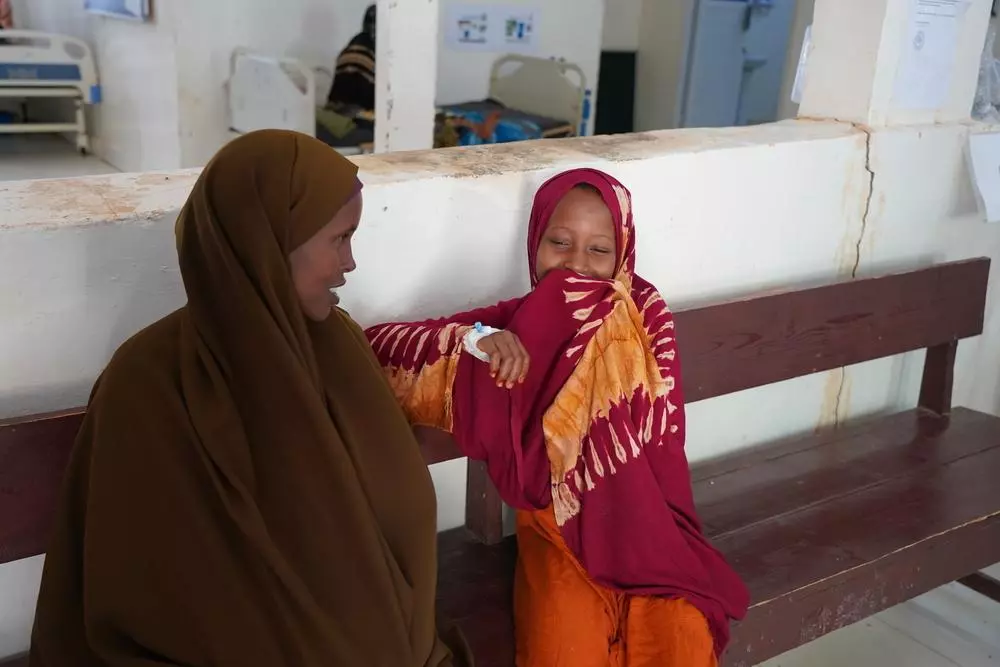 A patient hides her giggle as she sits next to her mother at Bay Regional hospital, during one of her regular check-up visits to manage her type 1 diabetes