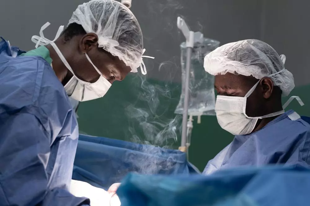 Surgeons at the Rutshuru General Reference hospital cauterize a wound of a young gunshot victim