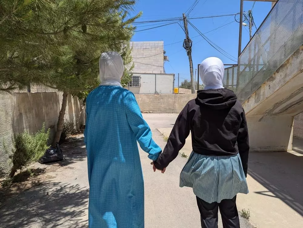 Two people holding hands 