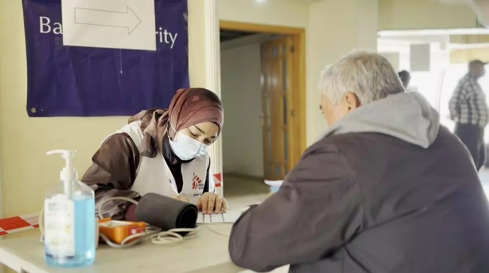 MSF staff talking with patient