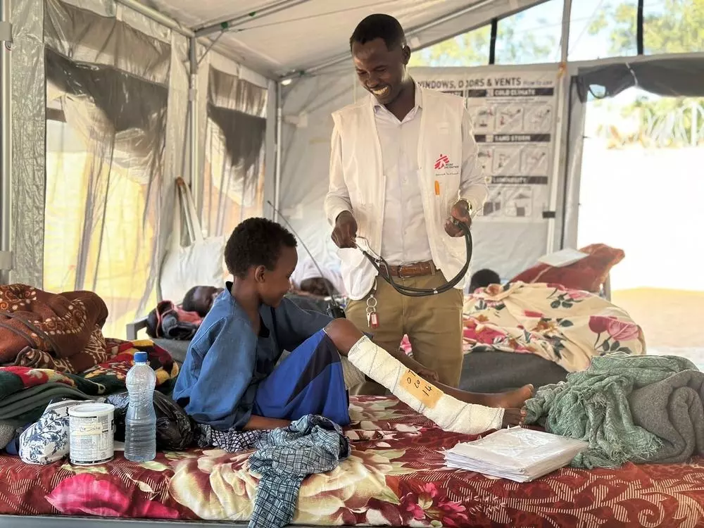 Sudanese doctor examines a child patient in Tawila hospital