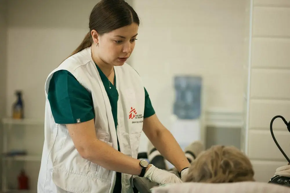 A Doctors Without Borders emergency doctor examines a 67-year-old patient in Ukraine