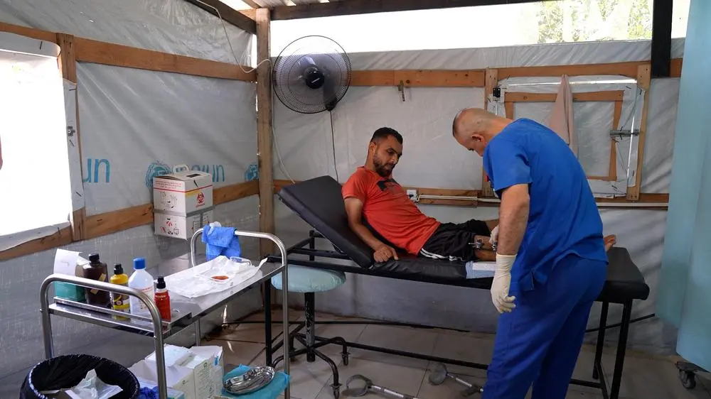 MSF staff checks on patient