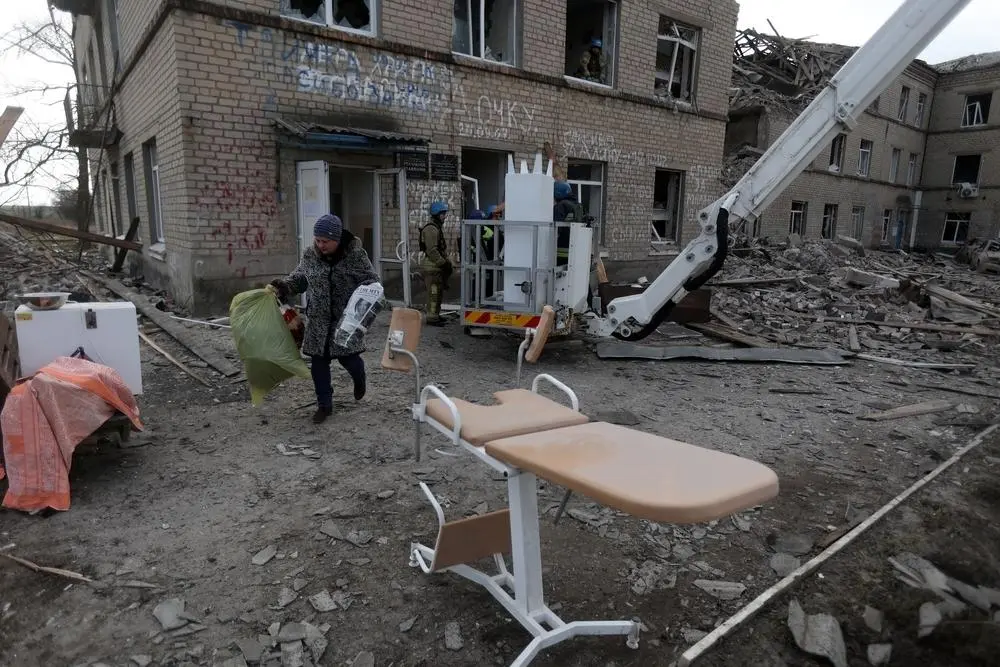 Employees of the State Emergency Service of Ukraine and medical staff evacuate medical equipment from a maternity hospital destroyed by a Russian missile attack in the town of Selydove, Donetsk region
